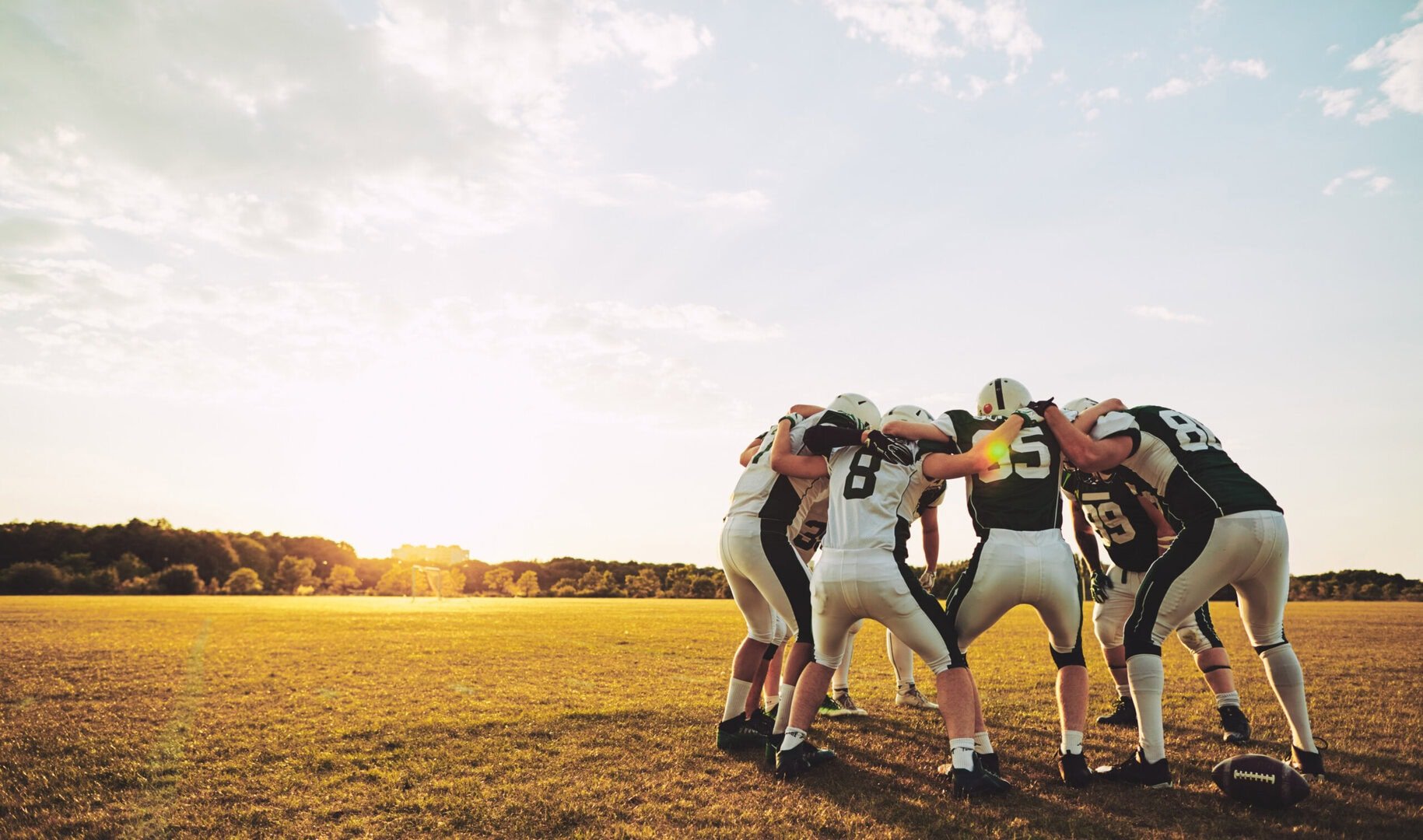 American footballers in a huddle.